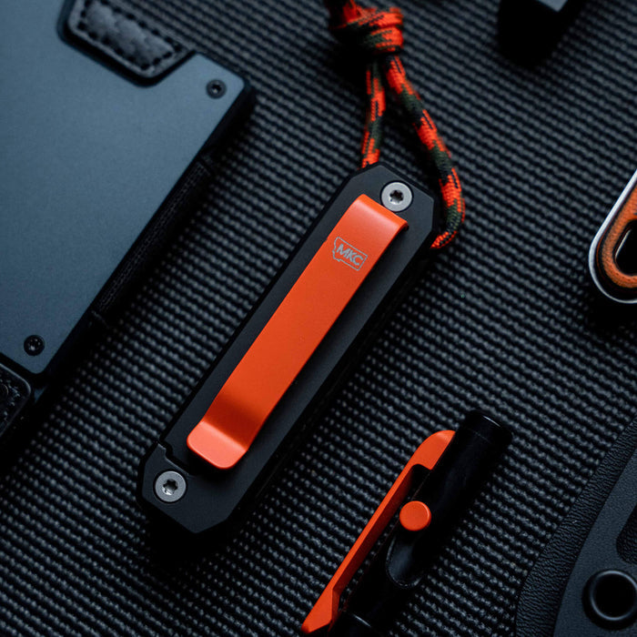 MKC Ti EDS II in black and orange, featuring a sleek design, ideal for everyday carry and outdoor use.