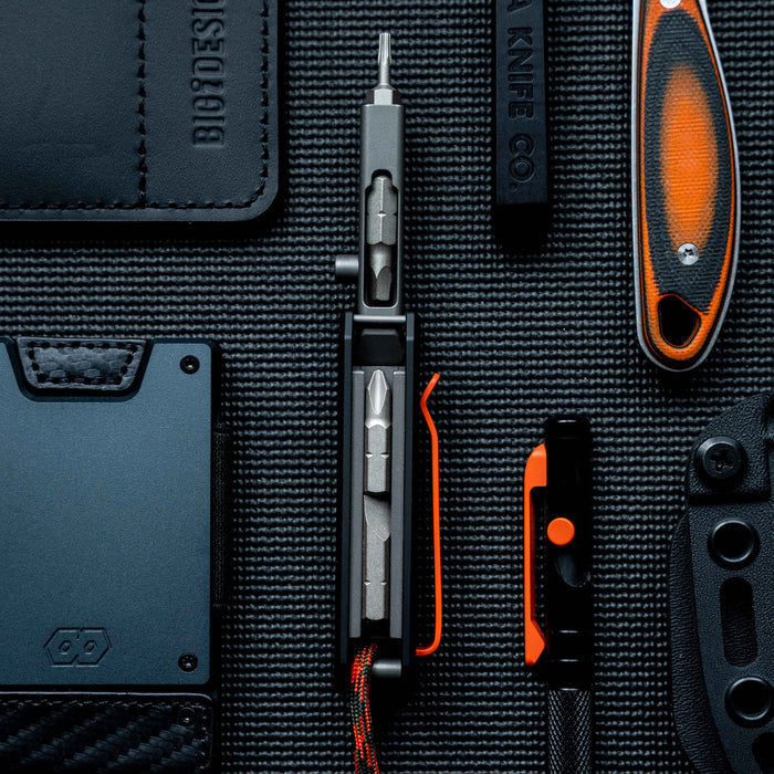 Montana Knife Company Ti EDS II tool displayed among various EDC items, showcasing its sleek design and functionality.