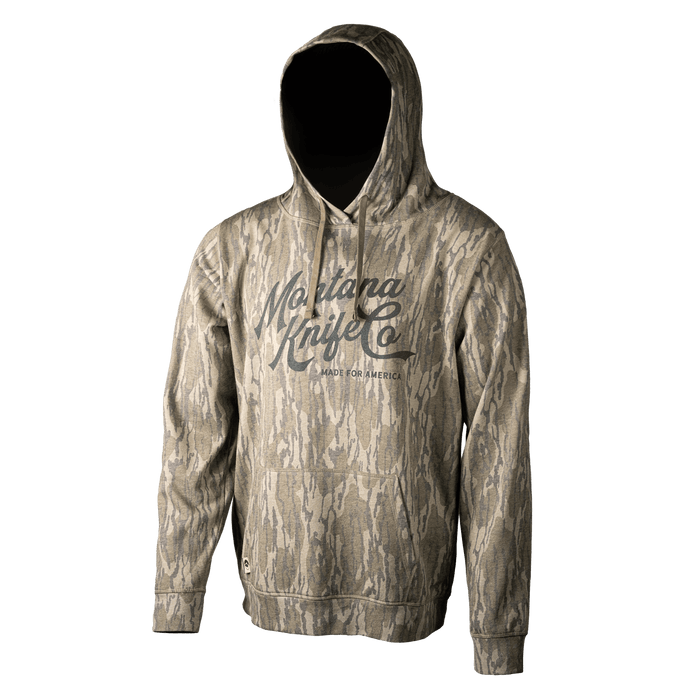 MKC x Mossy Oak washed hoodie in Bottomland camo, featuring a front logo, designed for outdoor enthusiasts.