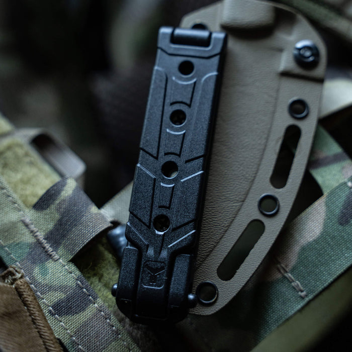 MOLLE-LOK attachment mounted on tactical gear, designed for secure knife and tool attachment in outdoor environments.