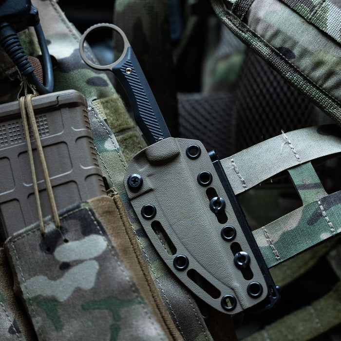 MOLLE-LOK attachment securely mounted on tactical gear, showcasing a knife sheath with adjustable hardware.