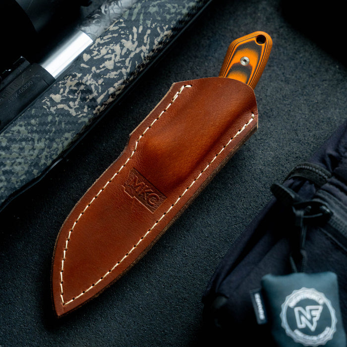 Mule Deer leather sheath designed for vertical belt carry, showcasing quality craftsmanship and durability for outdoor use.