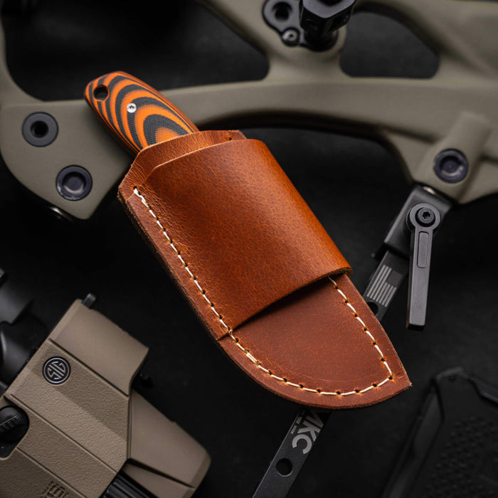 Horizontal leather sheath for PACKOUT knife, showcasing premium craftsmanship and durable design for easy belt carry.