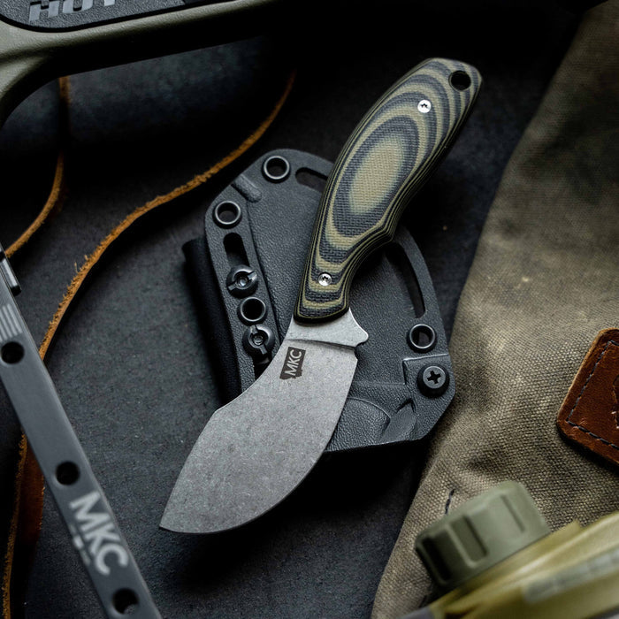 Montana Knife Company's PACKOUT SKINNER in green and black, featuring a durable blade and ergonomic handle, ideal for outdoor use.