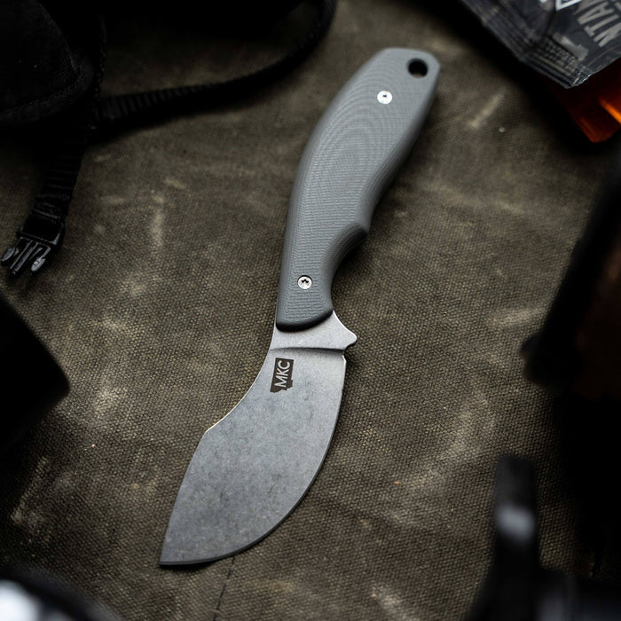 Grey PACKOUT SKINNER knife with a curved blade and textured handle, designed for outdoor and hunting use.