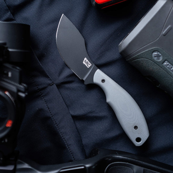 Montana Knife Company's PACKOUT SKINNER in grey, featuring a durable PVD-coated blade, ideal for outdoor use.
