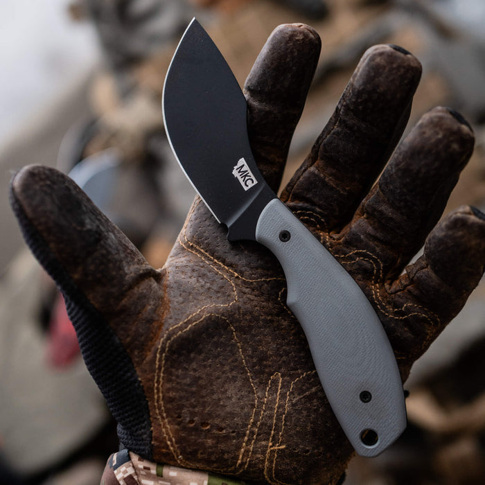 Montana Knife Company's PACKOUT SKINNER features a grey handle and PVD-coated blade, ideal for outdoor and hunting tasks.