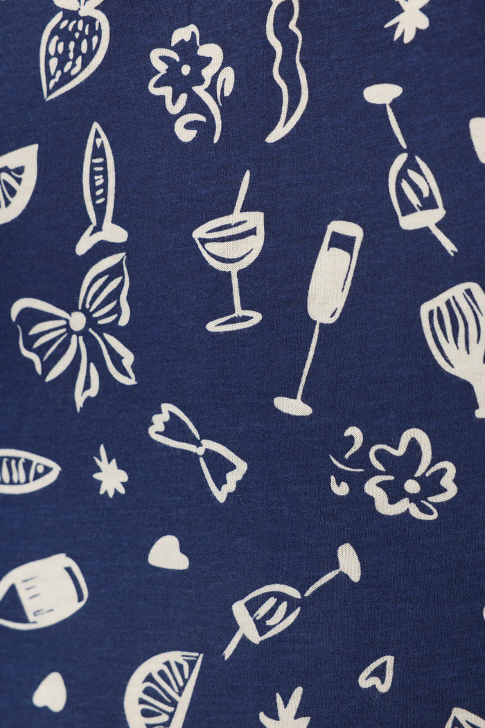 P.J. Salvage’s Playful Prints Al Fresco Bistro Sleep Shorts feature blue fabric with white cocktail, wine glass, citrus, and floral motifs—perfect for bringing the lively vibe of the Italian coast to your loungewear.