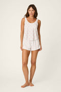A woman stands barefoot against a light background, wearing the P.J. Salvage Playful Prints All Wrapped Up Short PJ Set—perfect for a cozy girls’ night.