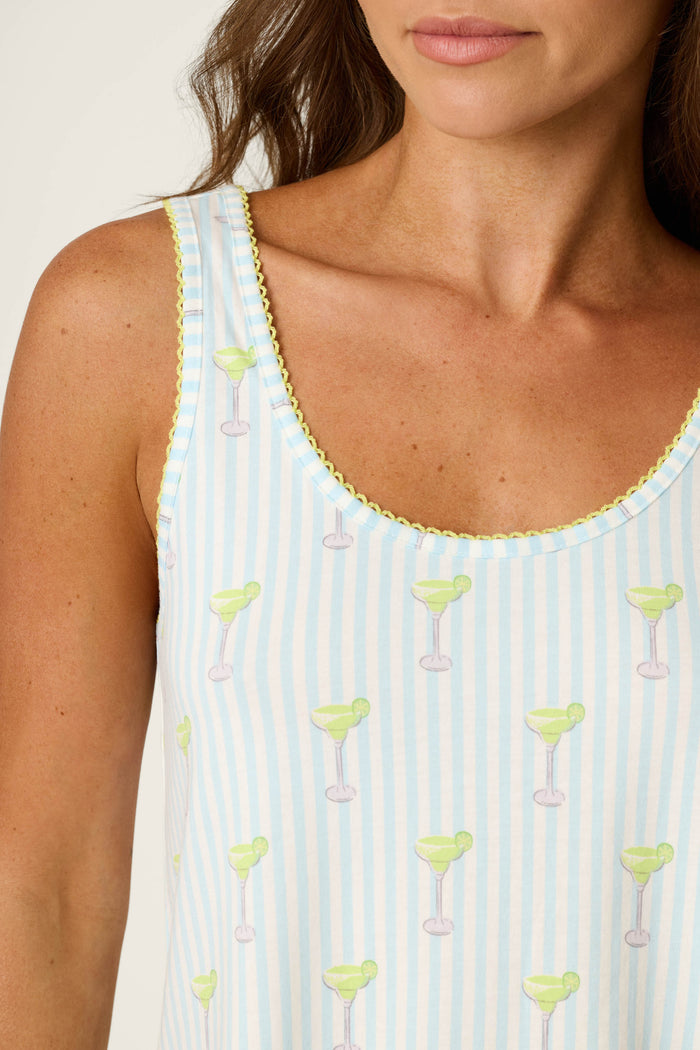 Blue and white stripes with margarita motifs and a yellow scalloped trim, smooth fabric texture.