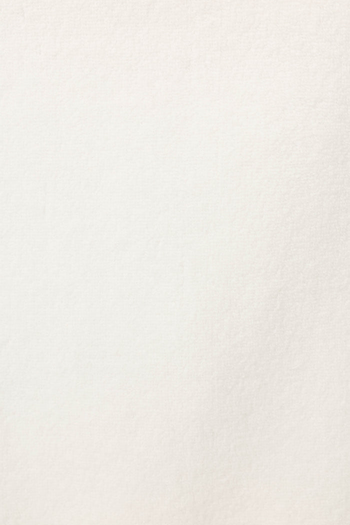 A close-up of the Playful Terry Happy Hour Robe by P.J. Salvage shows its off-white, textured terry fabric with subtle shading and fine grain.
