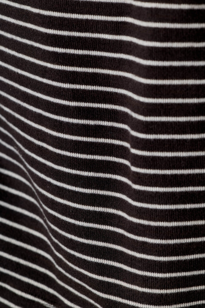A close-up of a black knit fabric with thin, evenly spaced horizontal white stripes.