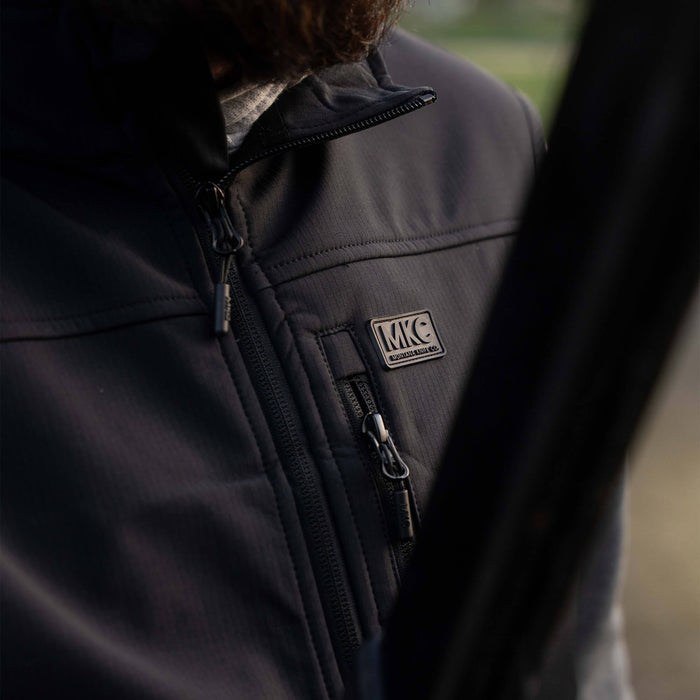 Black Rexford Ripstop Vest featuring a zippered front and MKC logo, designed for durability and outdoor use.