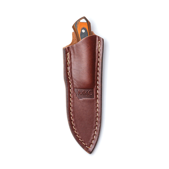 Vertical leather sheath for Montana Knife Company's Rocker knife, designed for secure belt carry and durability.