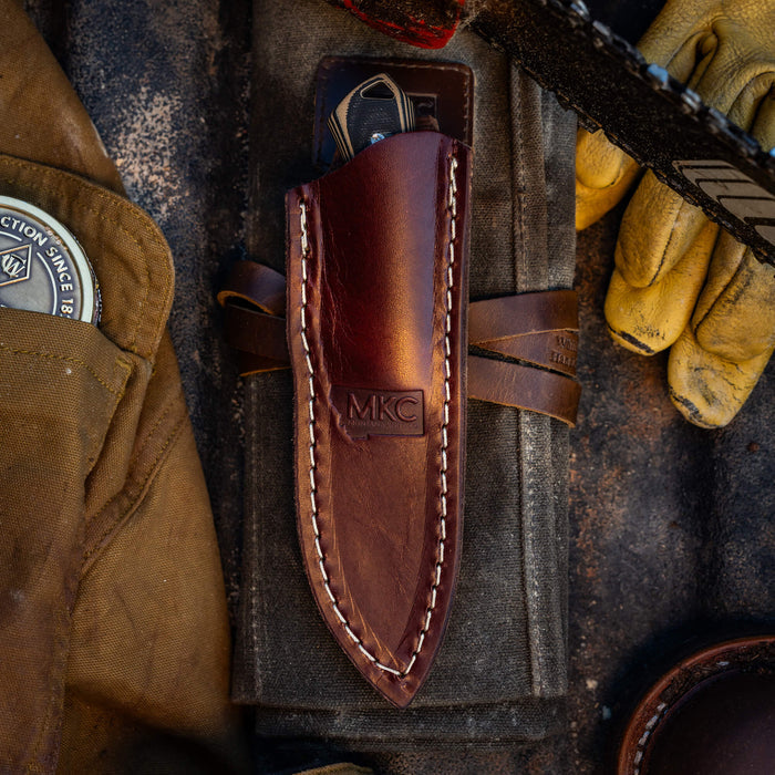 Rocker leather sheath for vertical belt carry, showcasing premium leather and MKC branding, ideal for outdoor use.