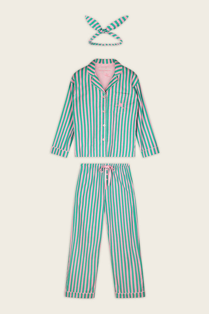 The P.J. Salvage Ski Bunny Icon 3-Piece Long Sleeve Flannel PJ Set includes a button-up long-sleeve top, matching drawstring pants, and a coordinating fabric headband. The set features vertical green, pink, and white stripes and is laid flat on a cream background.