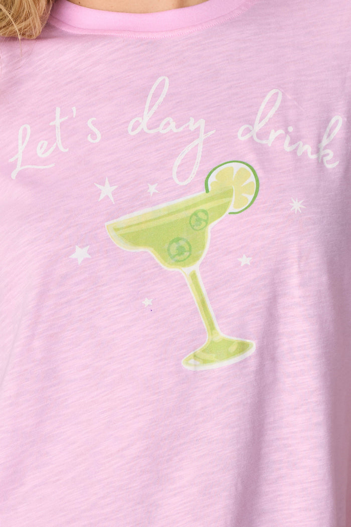 Close-up of the Softee "Let's Day Drink" Graphic Print Short PJ Set by P.J. Salvage, featuring a blush pink shirt with white script and a margarita glass—ideal for fans of fun, margarita-themed pajamas.