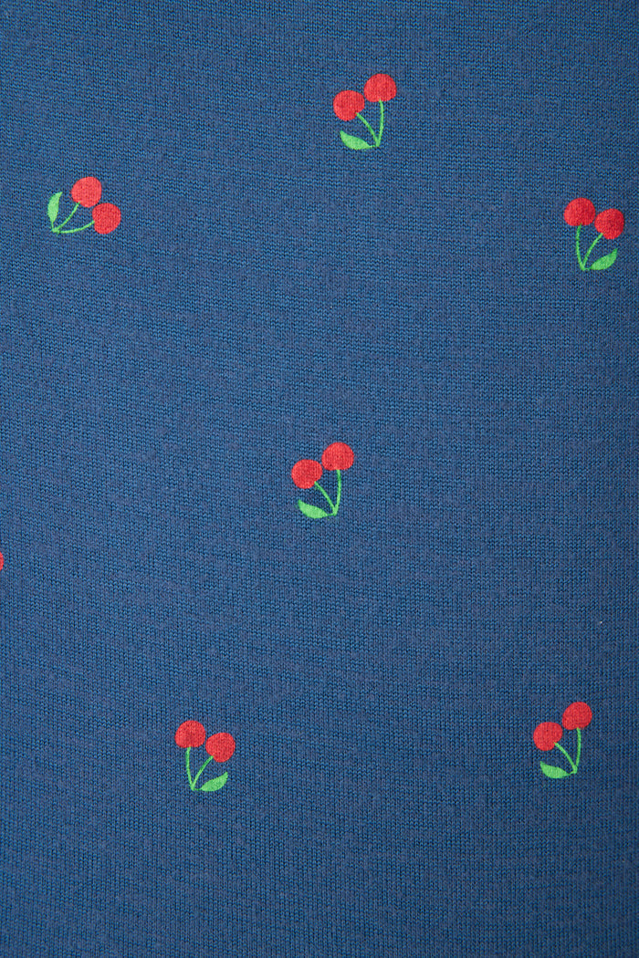 Blue fabric with a repeating pattern of small red cherries and green leaves, evenly spaced across the surface.