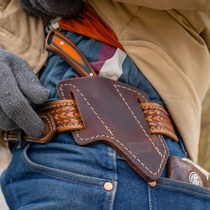 Angled leather sheath for secure belt carry, designed for Montana Knife Company's working knives. Durable and stylish.