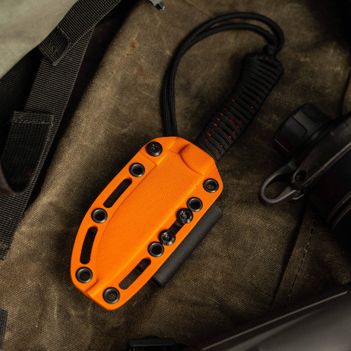 Additional Kydex sheath for the Stoned Goat 2.0 knife, featuring an orange finish and secure mounting options.