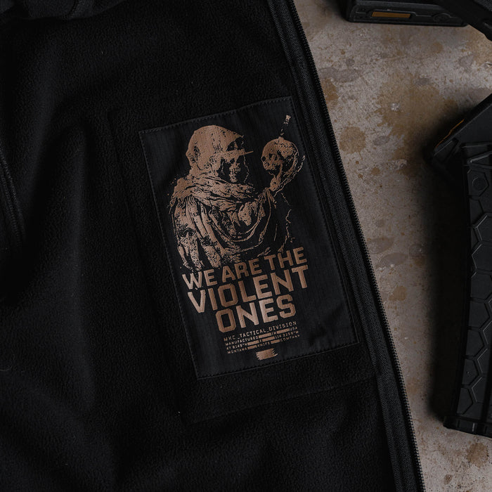 Tactical Striker softshell jacket featuring a graphic of a figure holding a skull with the text "We Are The Violent Ones.