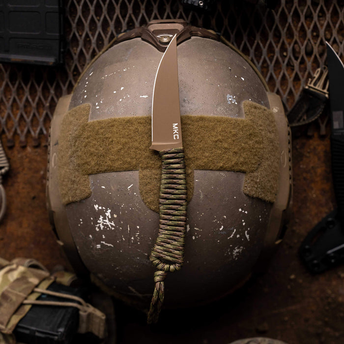 Tactical Speedgoat knife in Coy/Multicam finish displayed on a tactical helmet, showcasing its rugged design and utility.
