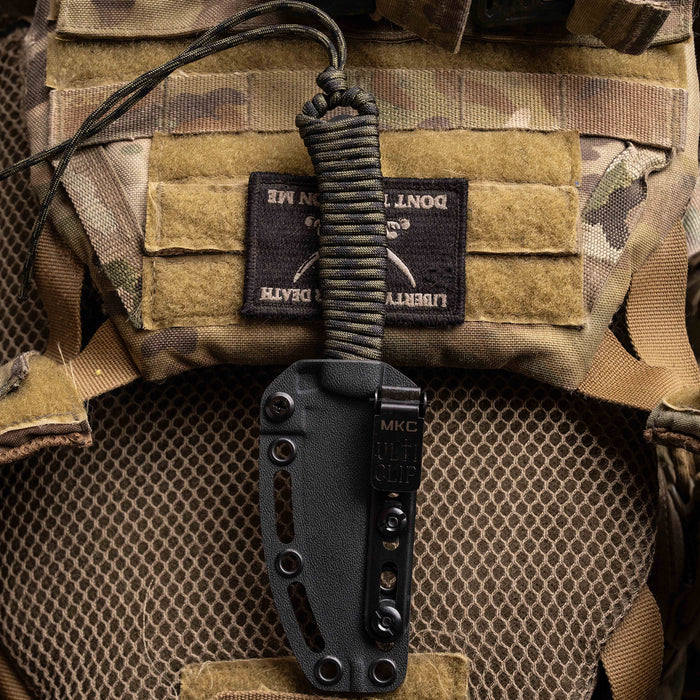 Kydex sheath for Tactical Speedgoat knife, featuring a durable design and paracord handle, displayed on tactical gear.