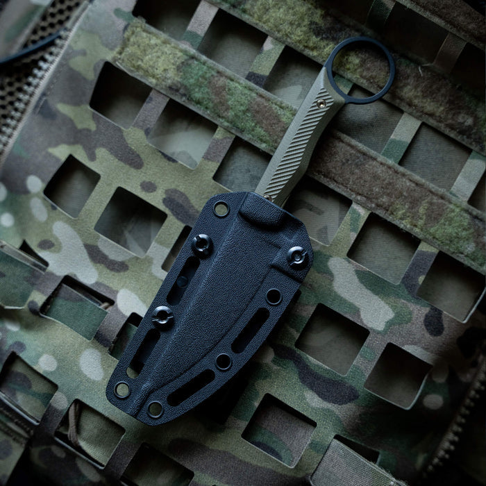 TEK-LOK belt attachment for secure knife carrying, mounted on a tactical camouflage background.