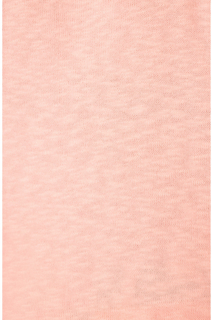 A close-up of light pink fabric with a subtle knit texture.