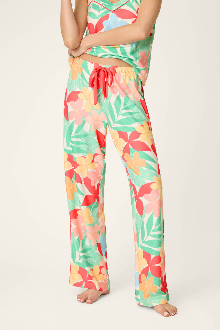 Vibrant tropical floral print in bold colors with a red drawstring accent; soft, smooth texture and loose, comfortable drape.