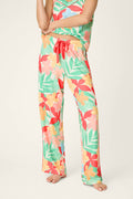Vibrant tropical floral print in bold colors with a red drawstring accent; soft, smooth texture and loose, comfortable drape.