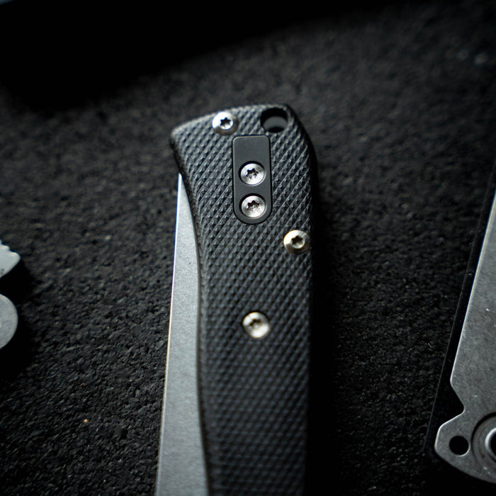 Close-up of the Montana Clip Deletion Kit knife handle featuring textured grip and stainless steel screws.