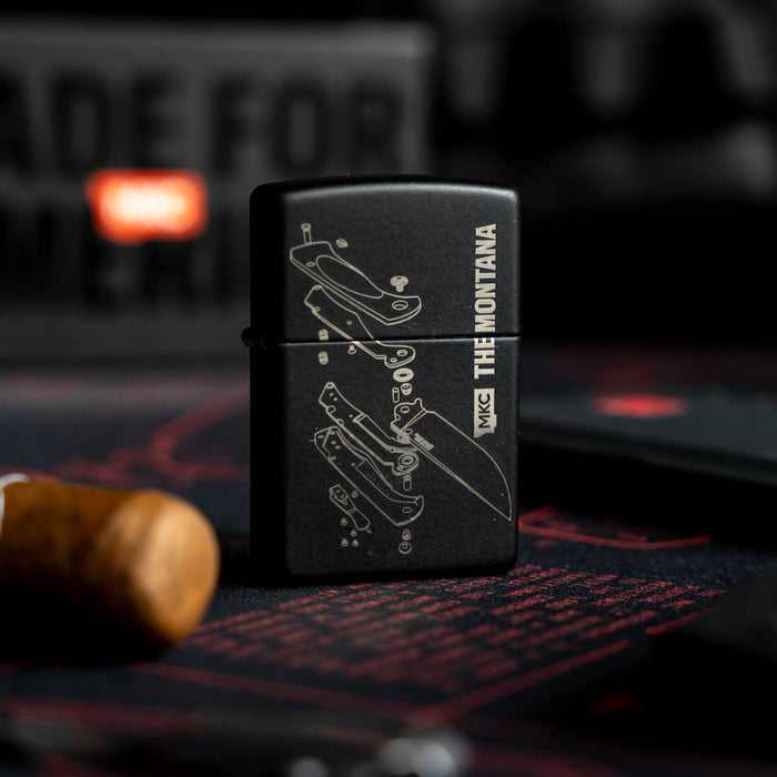 Black windproof Zippo lighter featuring a detailed knife diagram and "THE MONTANA" text, made in the USA.