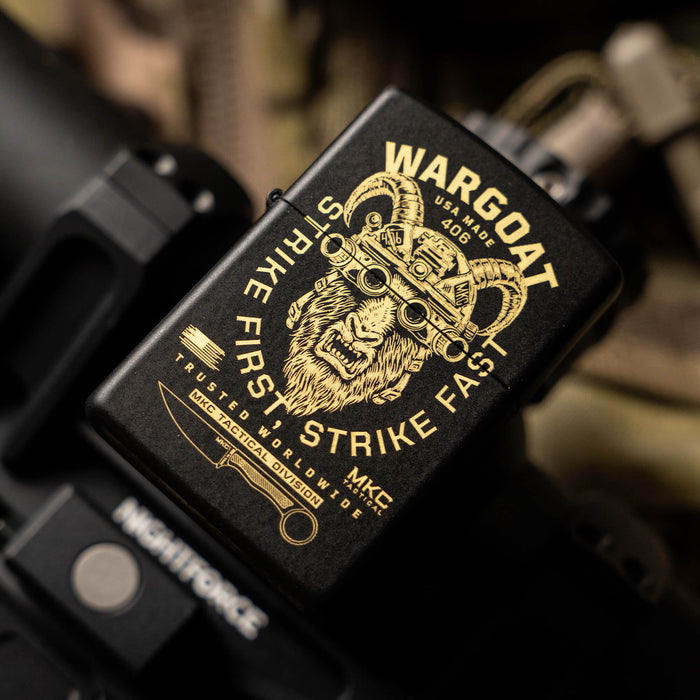 WARGOAT Zippo lighter featuring a detailed graphic of a goat's head with tactical elements, resting on a dark surface.