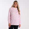 Woman wearing a pink and gray camouflage hoodie on a white background