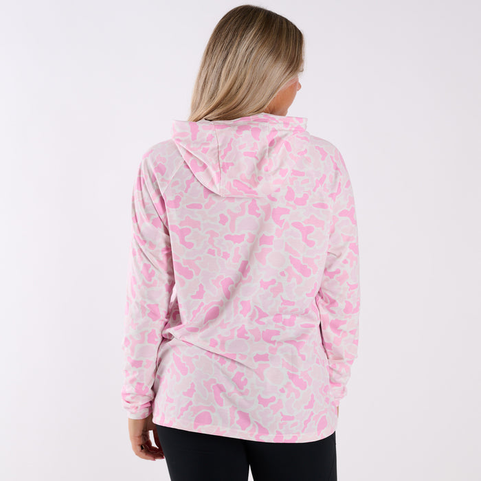 Person wearing a pink and gray patterned hoodie on a white background